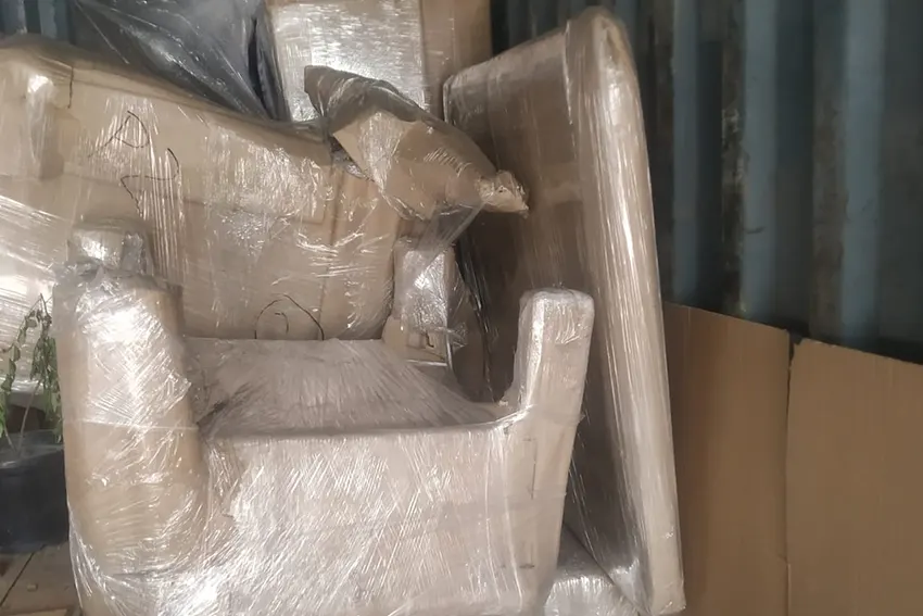 Household items packed in cardboard and wrapped for safety
